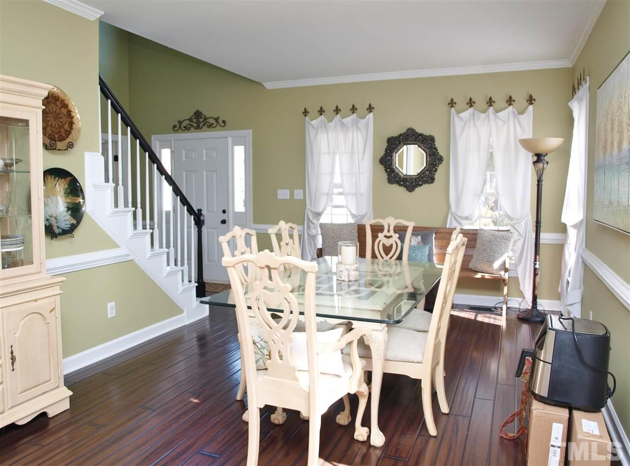 12009 Shavenrock Place Raleigh, NC 27613 - Photo 7 of 30 a view of a dining room with furniture and wooden floor
