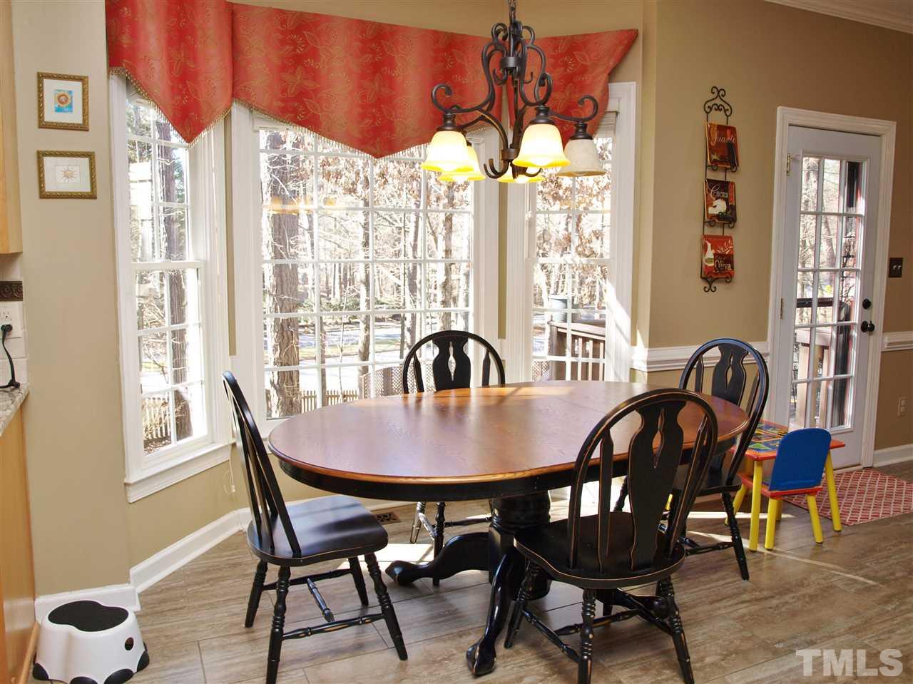 12009 Shavenrock Place Raleigh, NC 27613 - Photo 9 of 30 a view of a dining room with furniture window and outside view