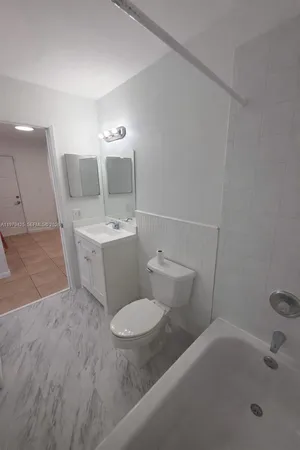 a bathroom with a sink toilet and mirror