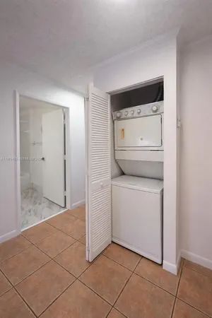 a utility room with cabinets washer and dryer