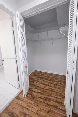 a view of a room with wooden floor and staircase
