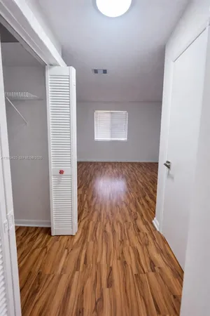 a view of a room with wooden floor