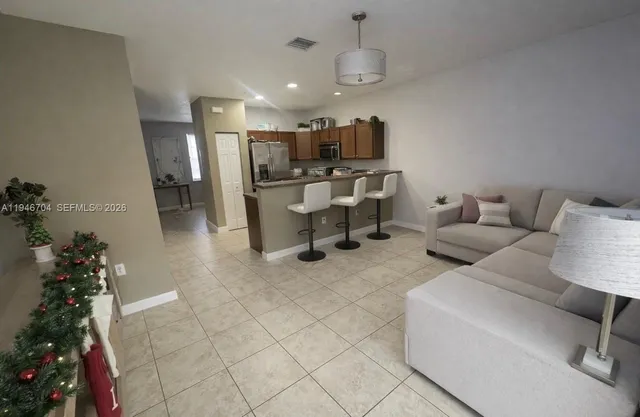 a living room with furniture and a potted plant