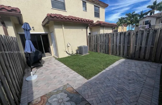 a view of a house with wooden fence