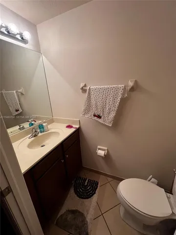 a bathroom with a sink toilet and a mirror