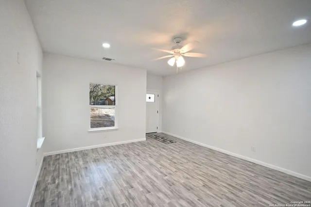 a kitchen with stainless steel appliances granite countertop a sink a stove and a refrigerator