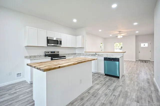 a view of kitchen and hall with wooden floor