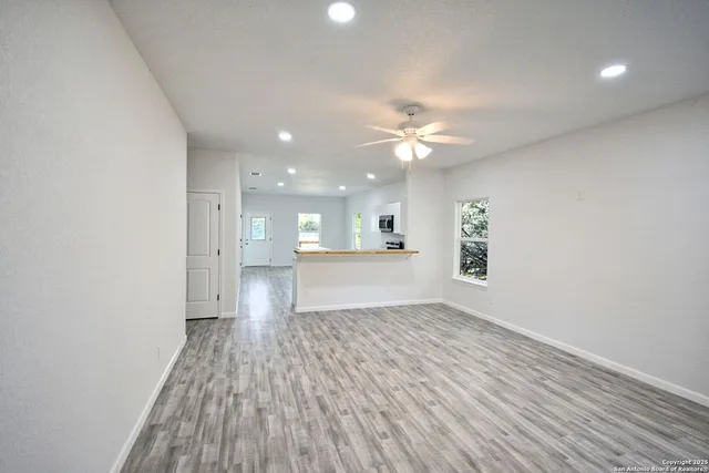 a kitchen with a sink cabinets stainless steel appliances and a window