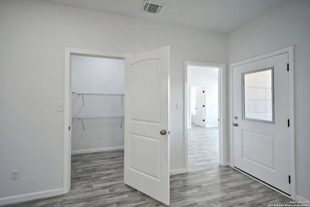 a view of hallway with wooden floor