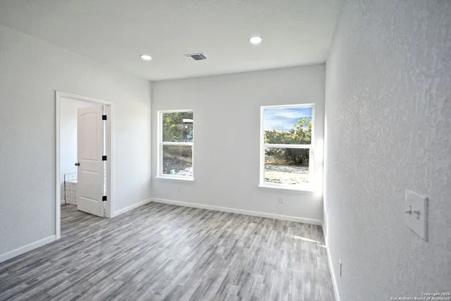 a view of a room with wooden floor