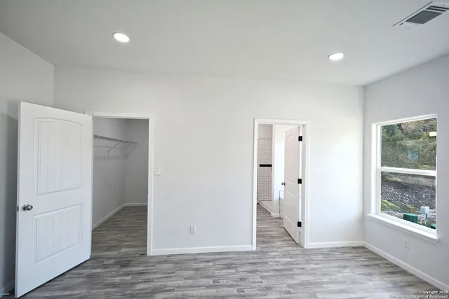 a kitchen with stainless steel appliances a sink a stove a refrigerator and cabinets
