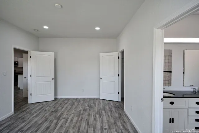 a bathroom with a double vanity sink and a mirror