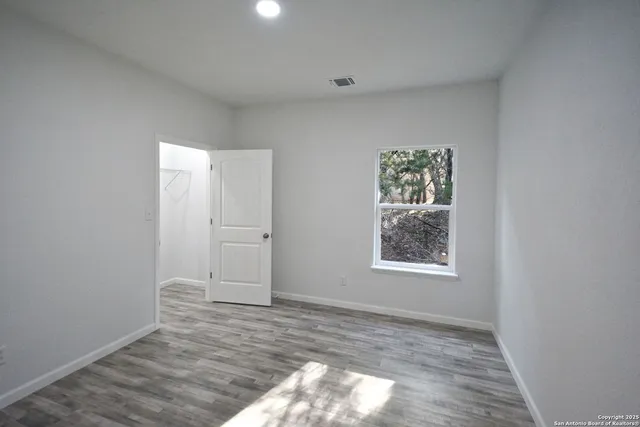 a view of an empty room and wooden floor