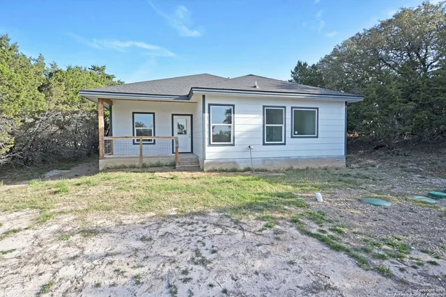 a view of a house with yard and sitting area