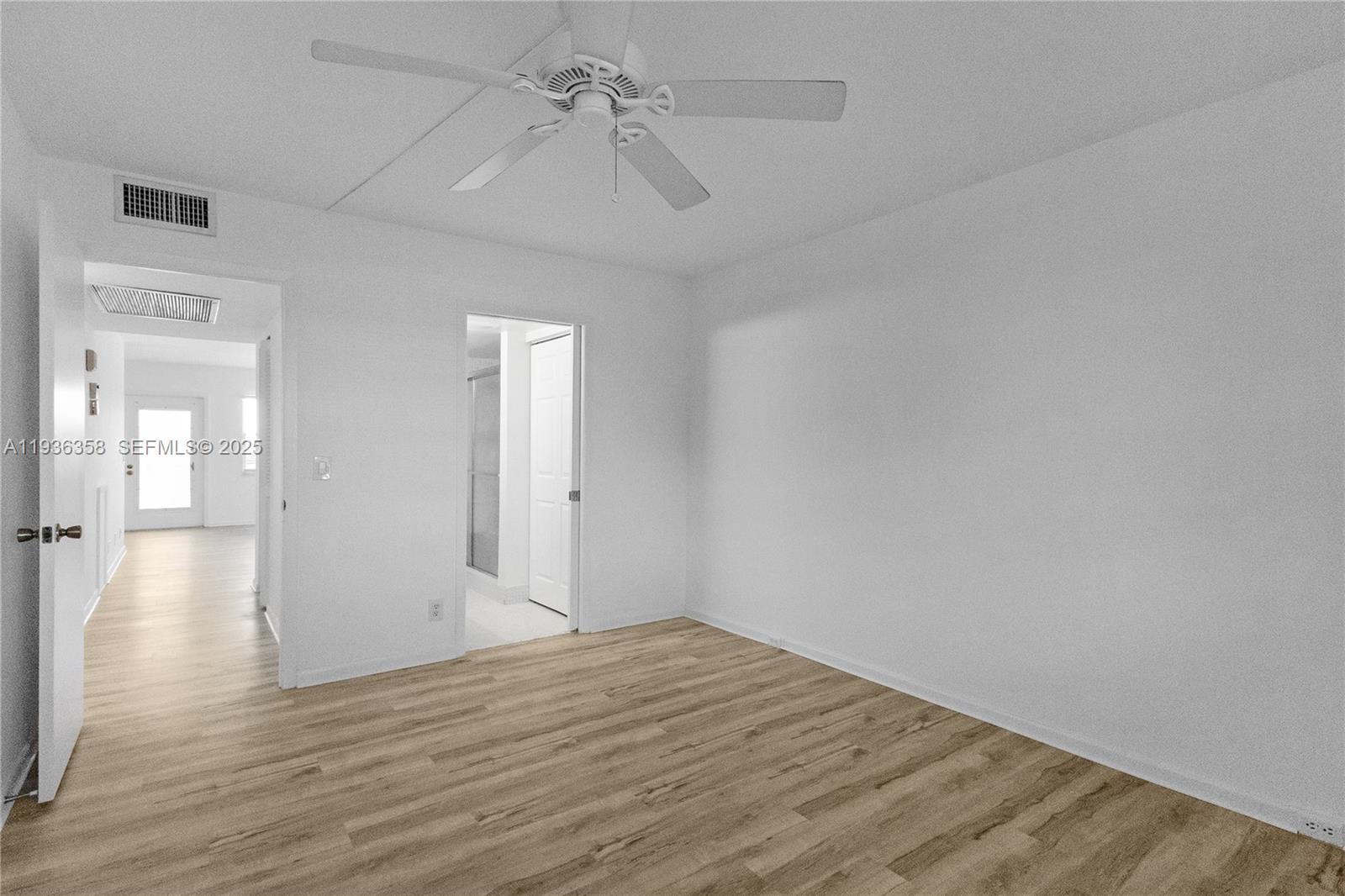 3030 Lincoln B, Unit 3030 Boca Raton, FL 33434 - Photo 11 of 25 a view of an empty room with wooden floor