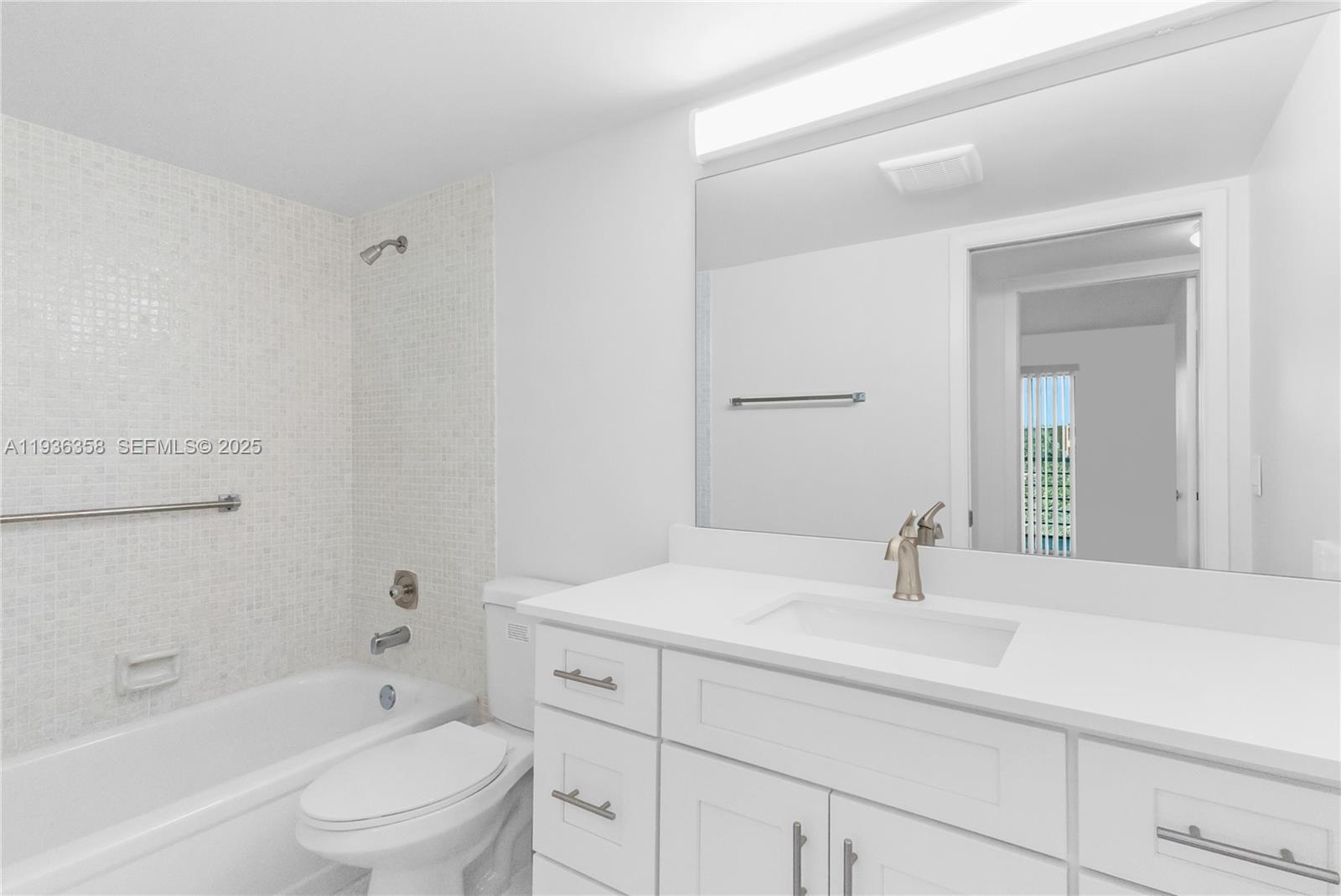 3030 Lincoln B, Unit 3030 Boca Raton, FL 33434 - Photo 13 of 25 a bathroom with a sink a toilet and shower