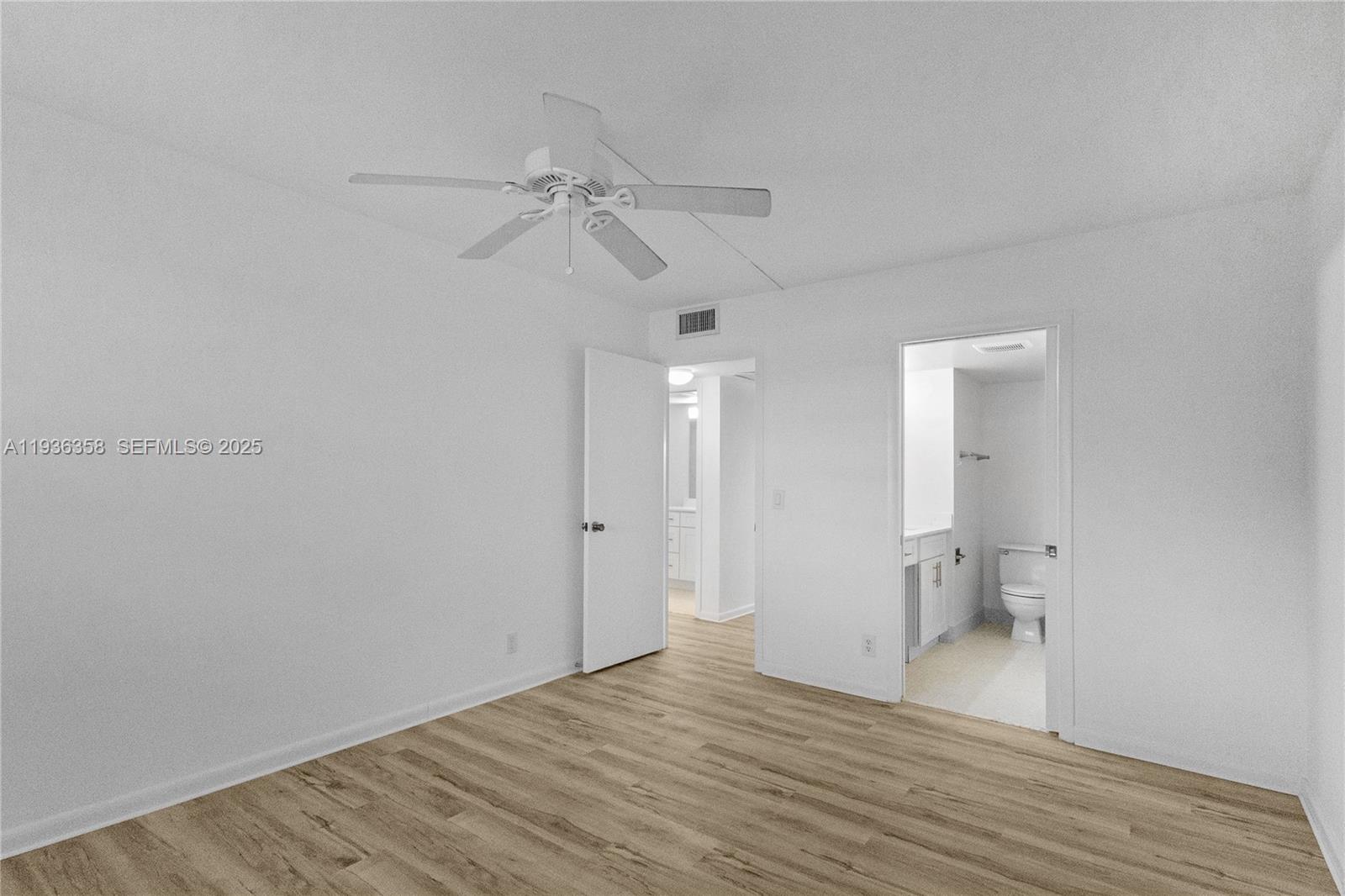 3030 Lincoln B, Unit 3030 Boca Raton, FL 33434 - Photo 14 of 25 a view of empty room with wooden floor and fan