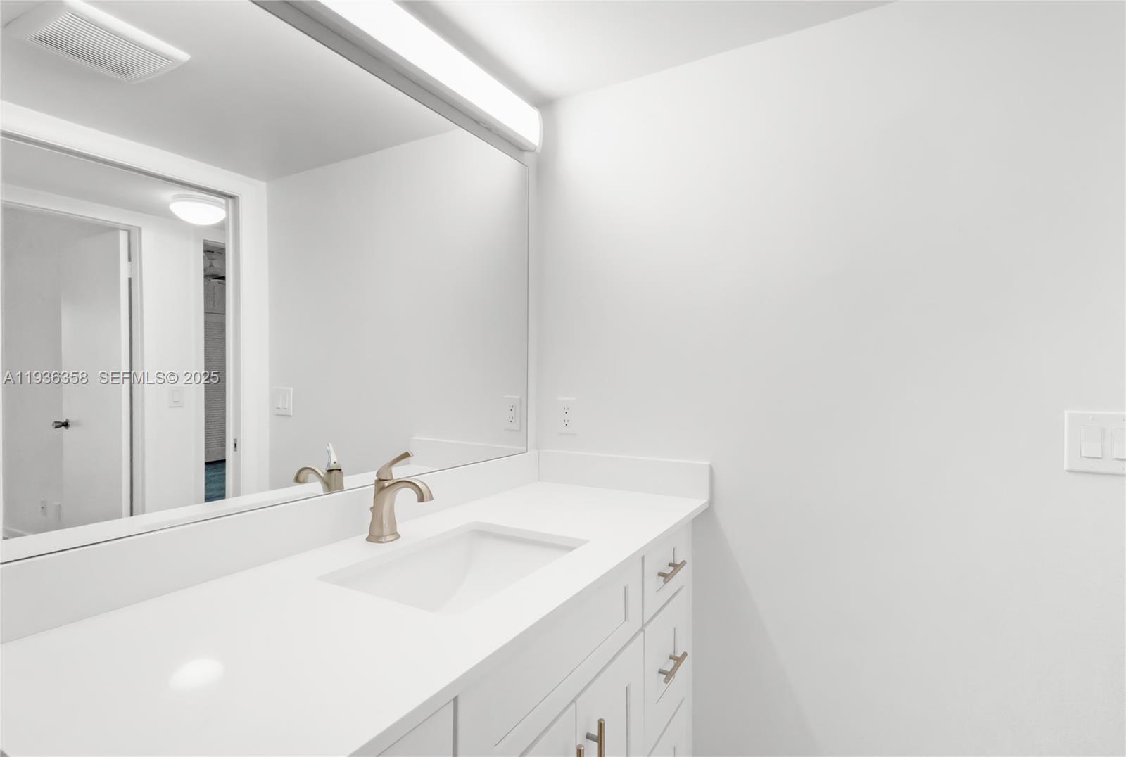 3030 Lincoln B, Unit 3030 Boca Raton, FL 33434 - Photo 17 of 25 a bathroom with a sink and a mirror