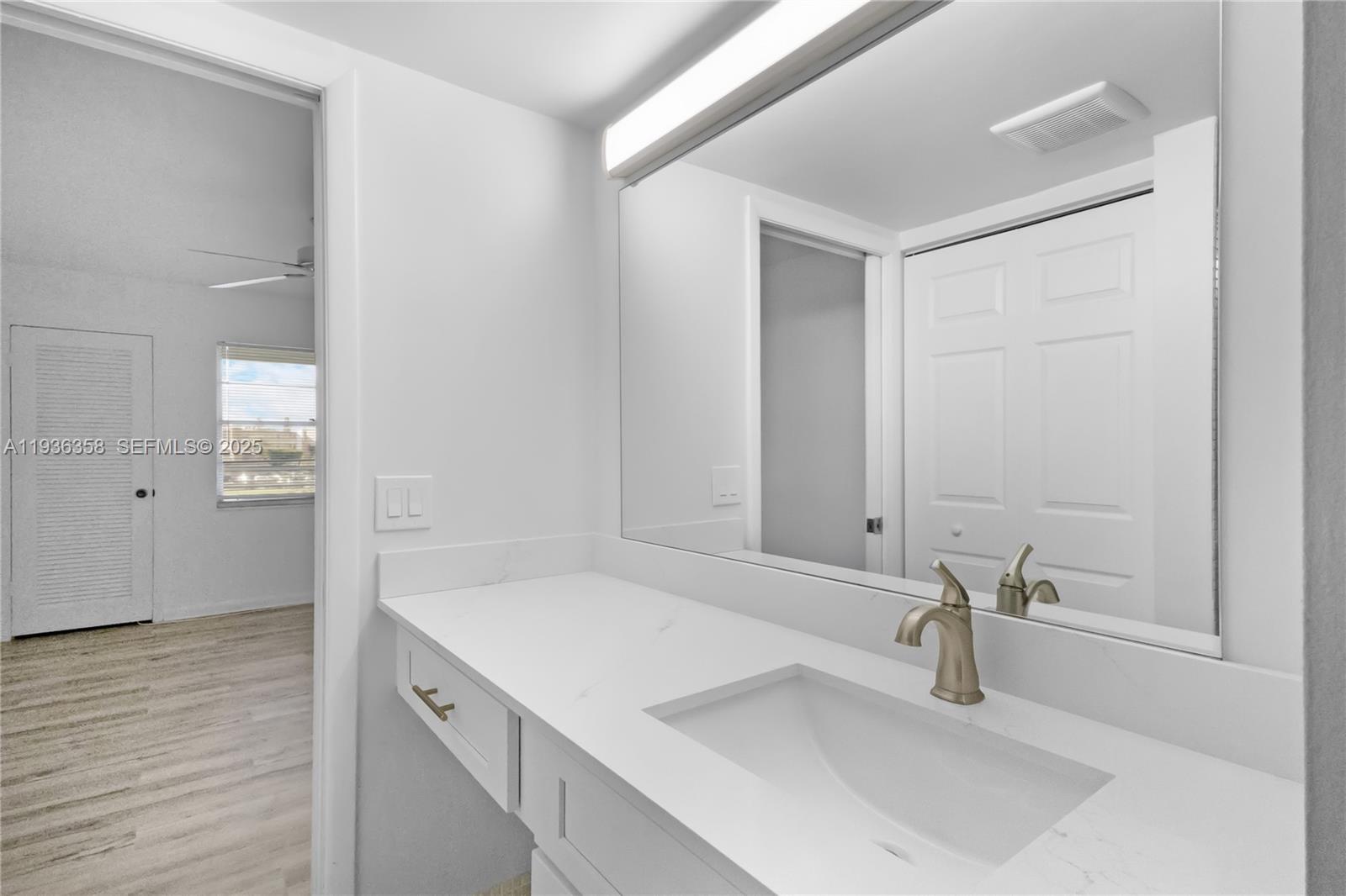 3030 Lincoln B, Unit 3030 Boca Raton, FL 33434 - Photo 19 of 25 a bathroom with a sink and a mirror