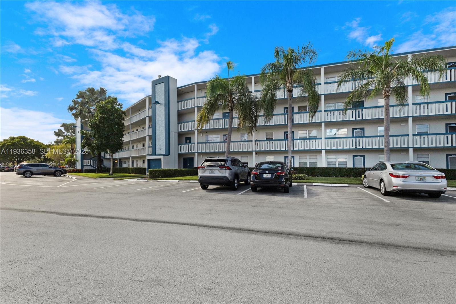 3030 Lincoln B, Unit 3030 Boca Raton, FL 33434 - Photo 2 of 25 a car parked in front of a building