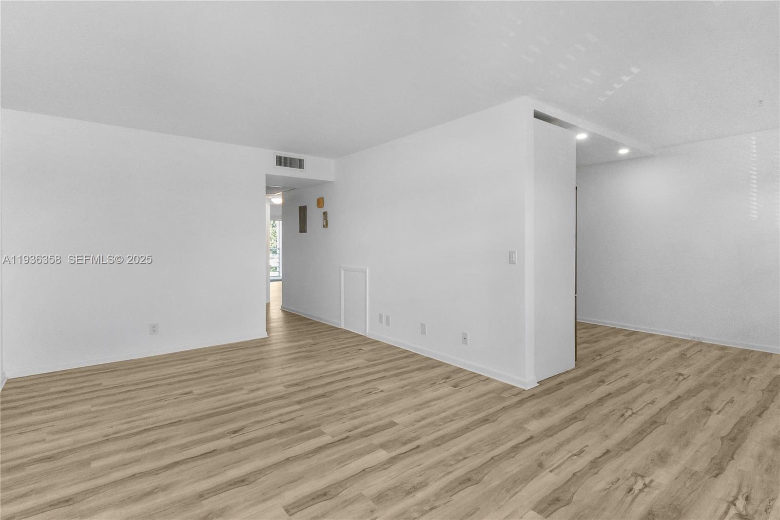 3030 Lincoln B, Unit 3030 Boca Raton, FL 33434 - Photo 6 of 25 a view of an empty room with wooden floor