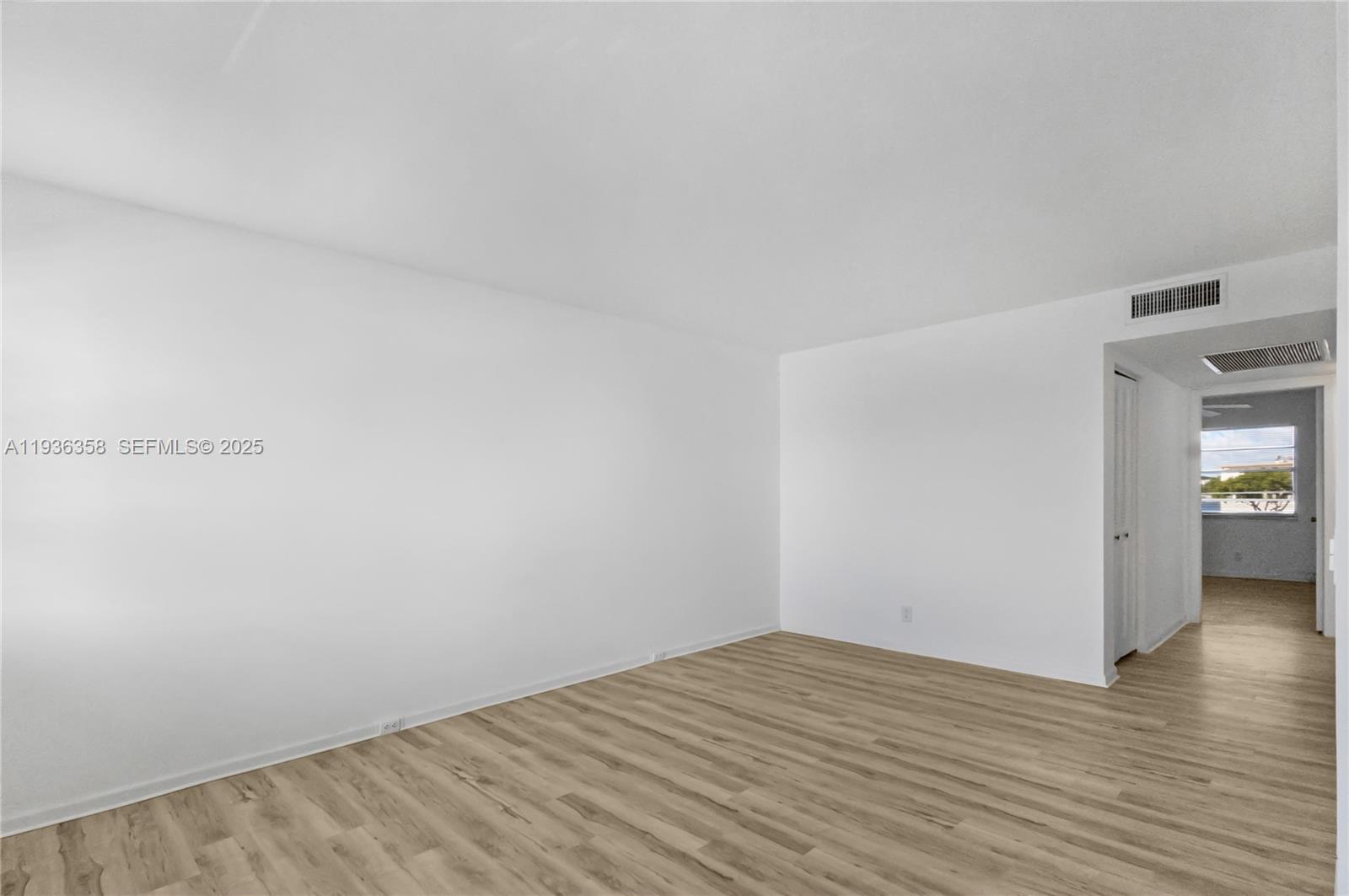 3030 Lincoln B, Unit 3030 Boca Raton, FL 33434 - Photo 7 of 25 a view of empty room with wooden floor