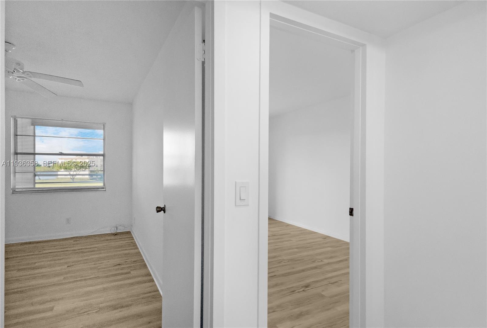 3030 Lincoln B, Unit 3030 Boca Raton, FL 33434 - Photo 10 of 25 a view of a hallway with wooden floor