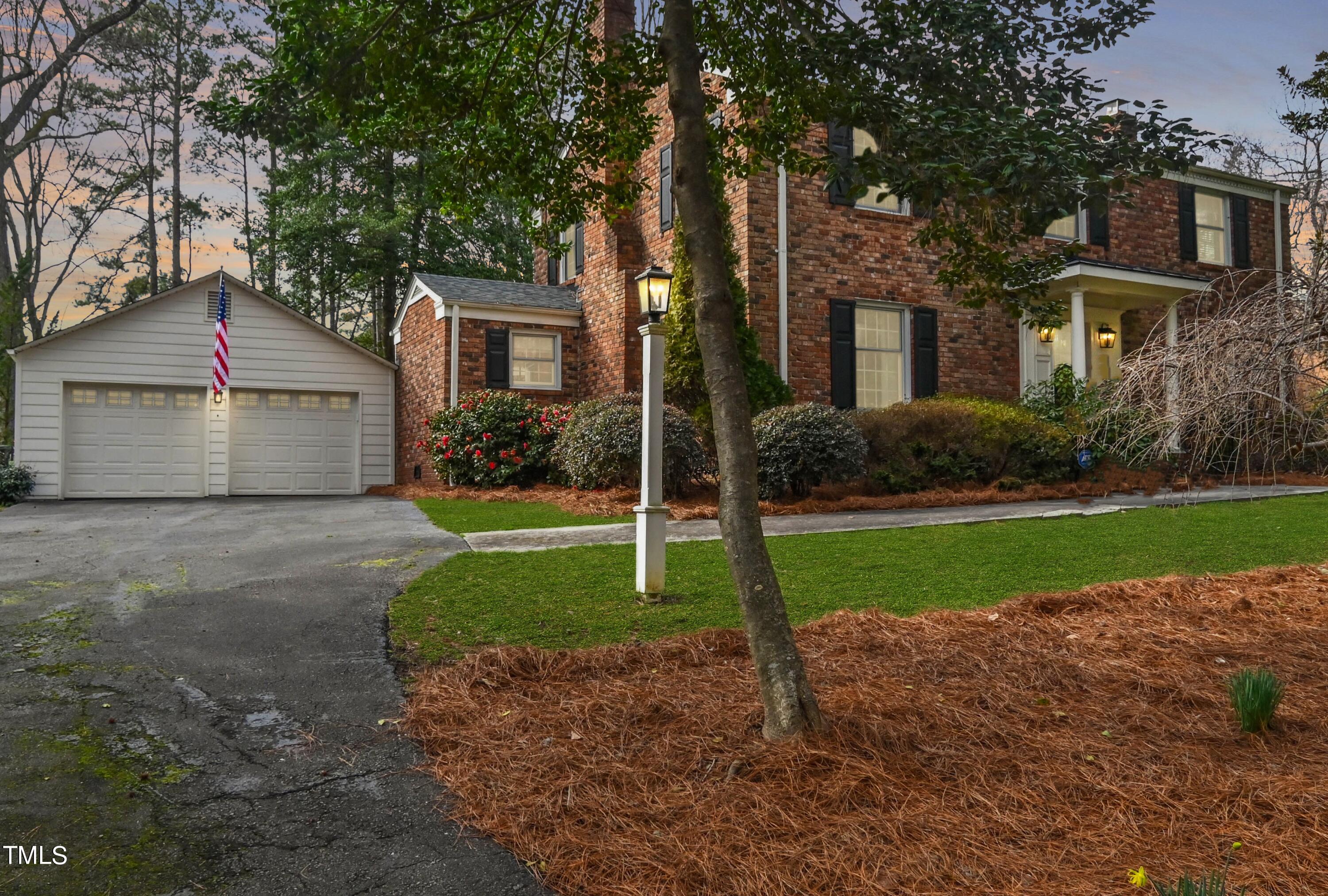 5313 Alpine Drive Raleigh, NC 27609 - Photo 19 of 20 a front view of a house with a yard and garage