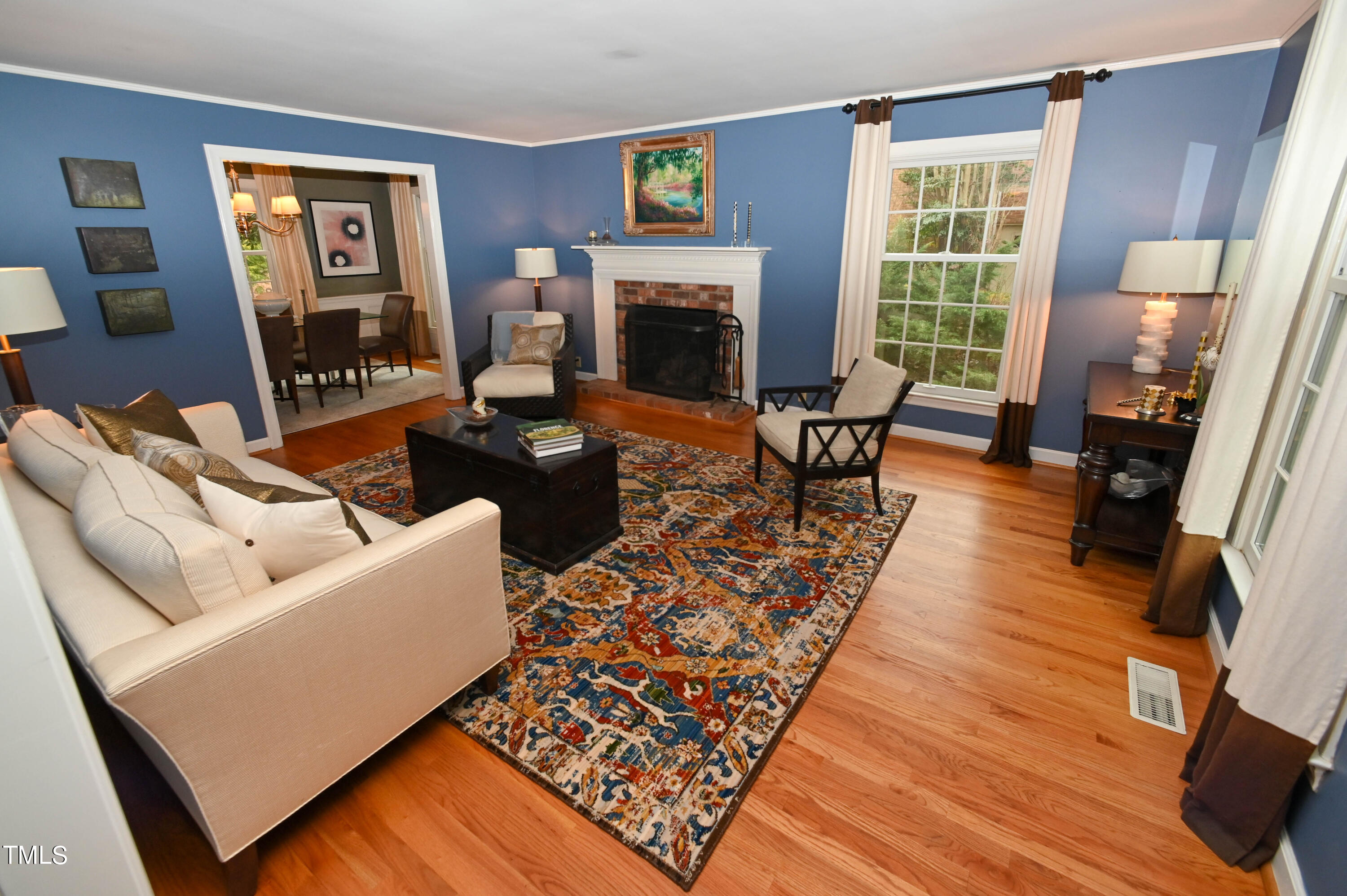 5313 Alpine Drive Raleigh, NC 27609 - Photo 5 of 20 a living room with furniture and a fireplace
