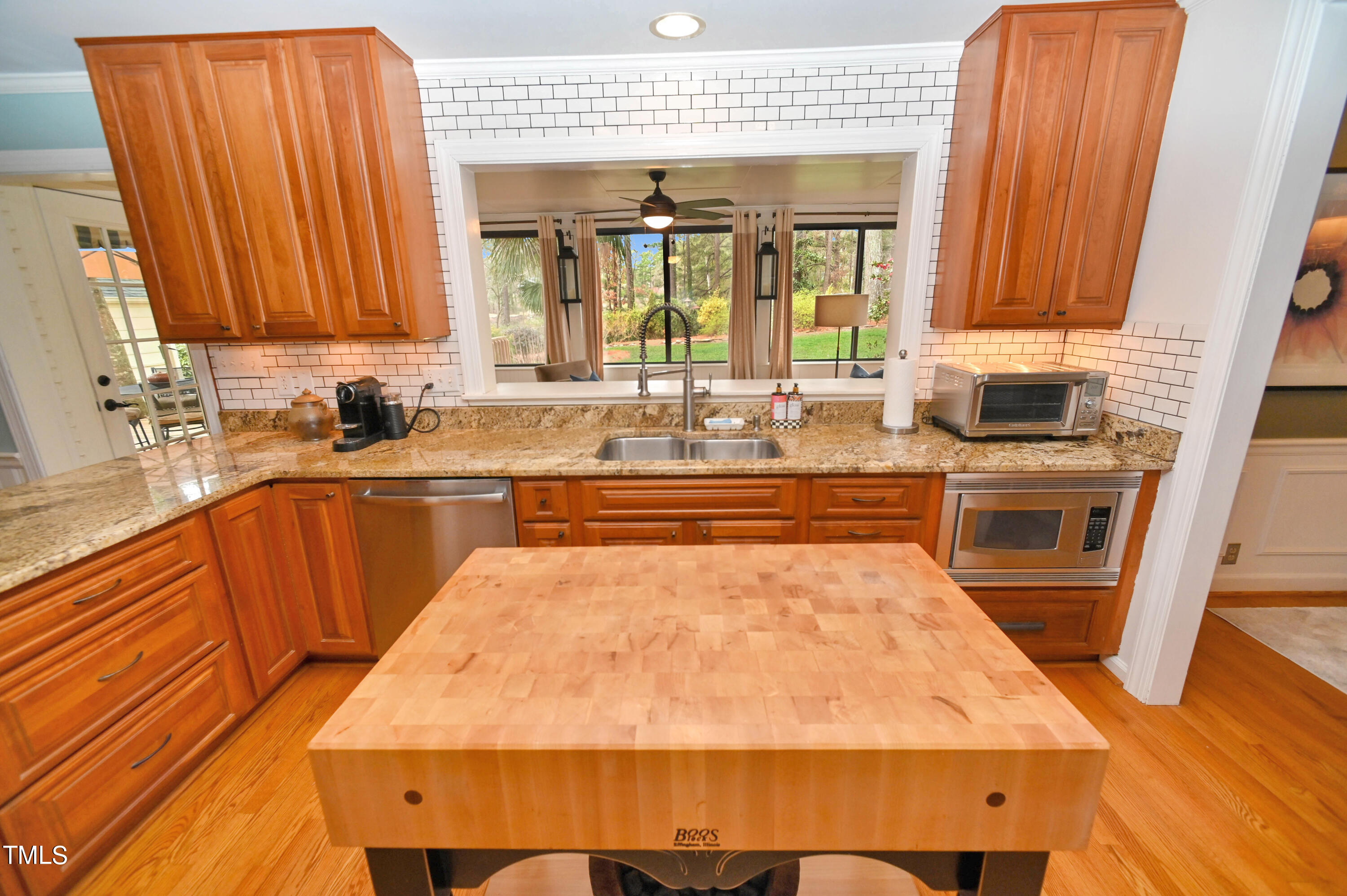 5313 Alpine Drive Raleigh, NC 27609 - Photo 8 of 20 a large kitchen with wooden floor and stainless steel appliances