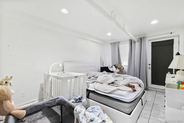 a bedroom with a bed and a mirror