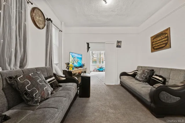 a living room with furniture a couch and a large window