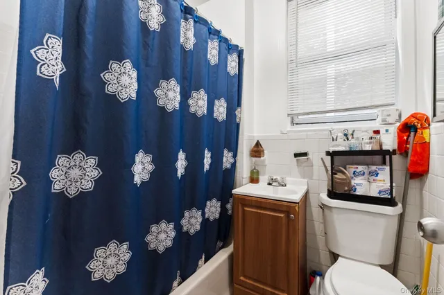 a bathroom with a sink mirror and toilet