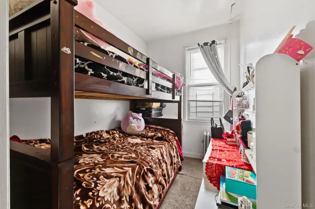a bedroom with two bed and a painting on the wall