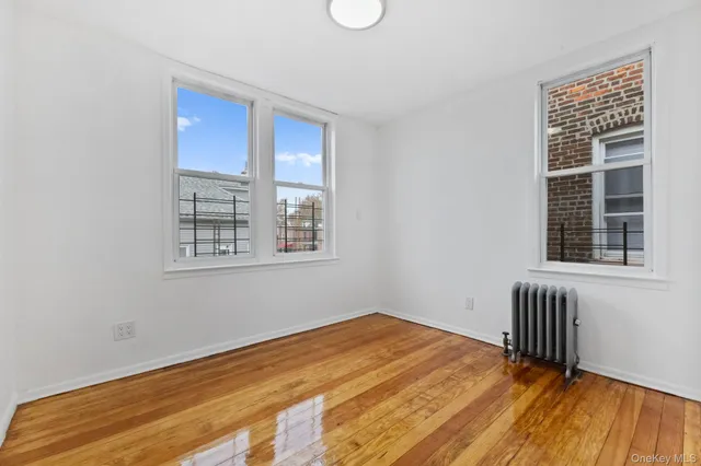 a view of a room with wooden floor and windows