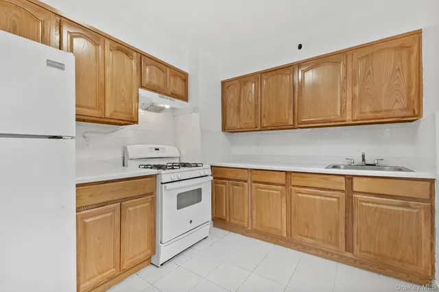 a kitchen with granite countertop cabinets stainless steel appliances and a sink