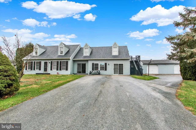a front view of a house with a garden and yard