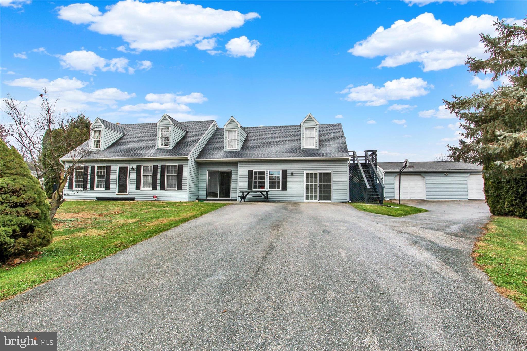 a front view of a house with a garden and yard