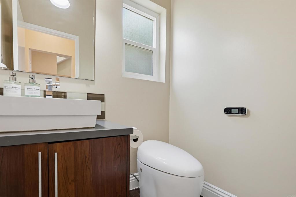 2756 Southampton Road Carlsbad, CA 92010 - Photo 21 of 40 a bathroom with a sink a toilet and mirror
