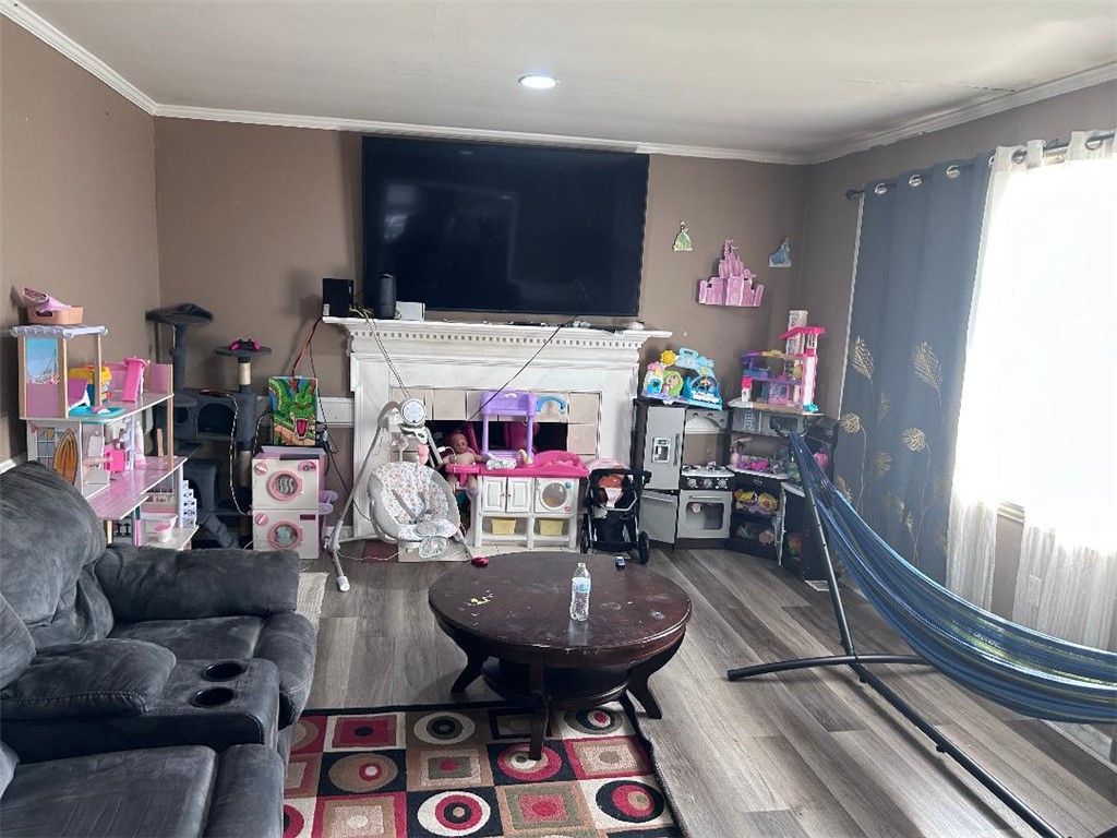 213 East Shockley Ferry Road Anderson, SC 29624 - Photo 15 of 20 This living area features a fireplace and wood flooring, ideal for comfortable gatherings.