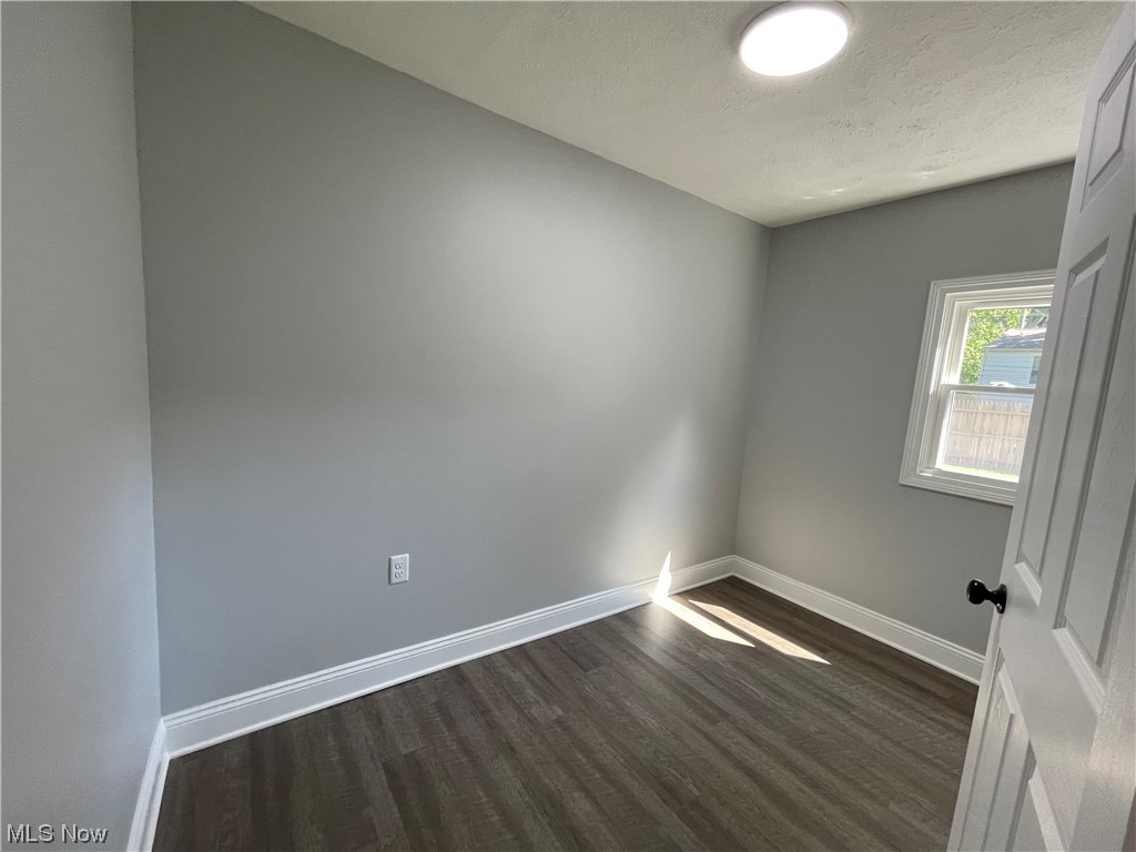1857 Sterling Road Madison, OH 44057 - Photo 17 of 33 Wood floored empty room with a textured ceiling