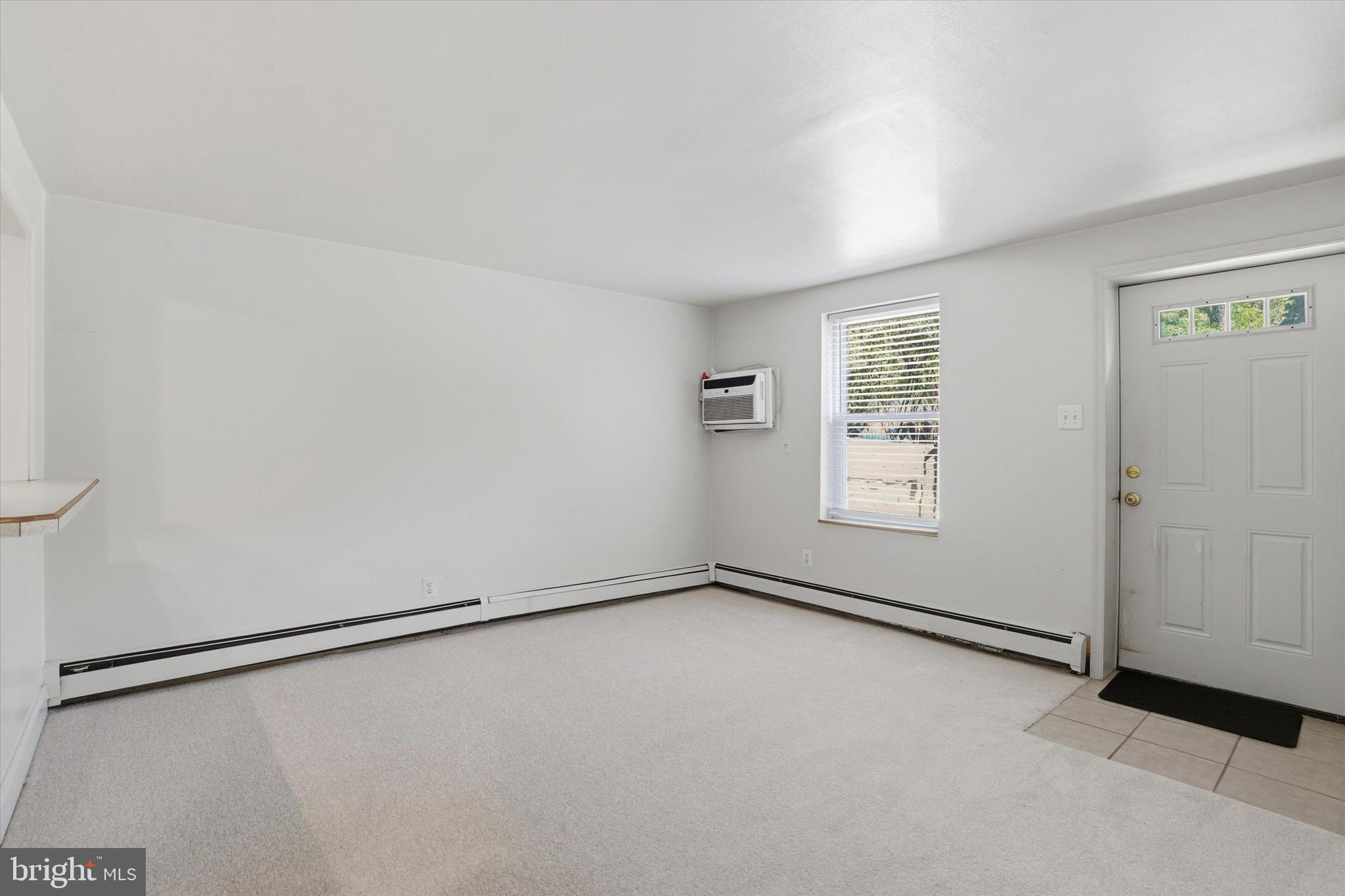 207 Walnut Hill Road, Unit B1 West Chester, PA 19382 - Photo 4 of 13 an empty room with windows