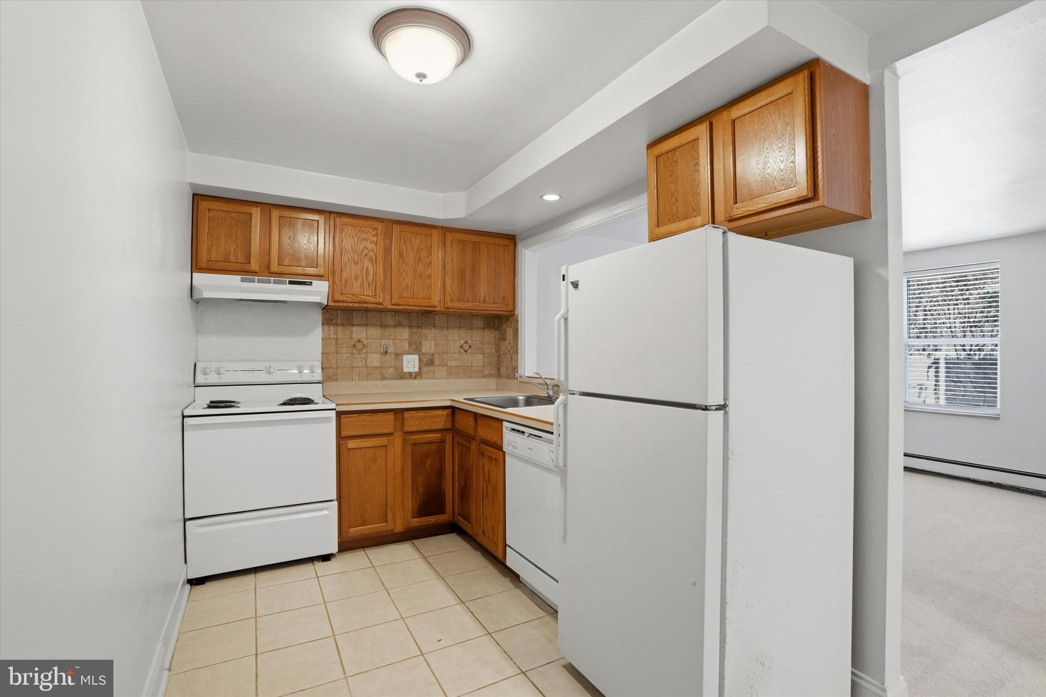 207 Walnut Hill Road, Unit B1 West Chester, PA 19382 - Photo 7 of 13 a white refrigerator freezer and a stove in a kitchen