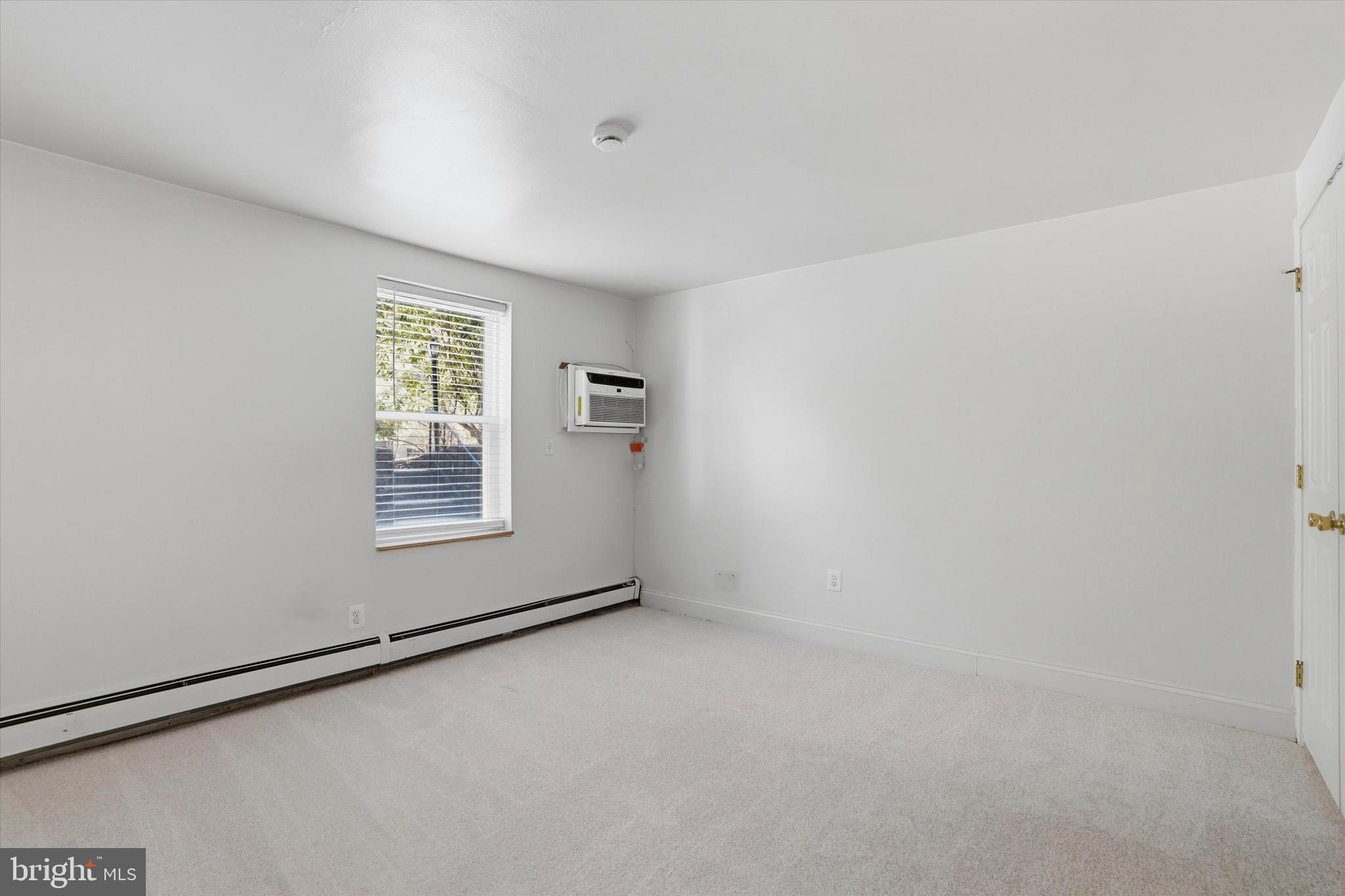 207 Walnut Hill Road, Unit B1 West Chester, PA 19382 - Photo 8 of 13 an empty room with windows