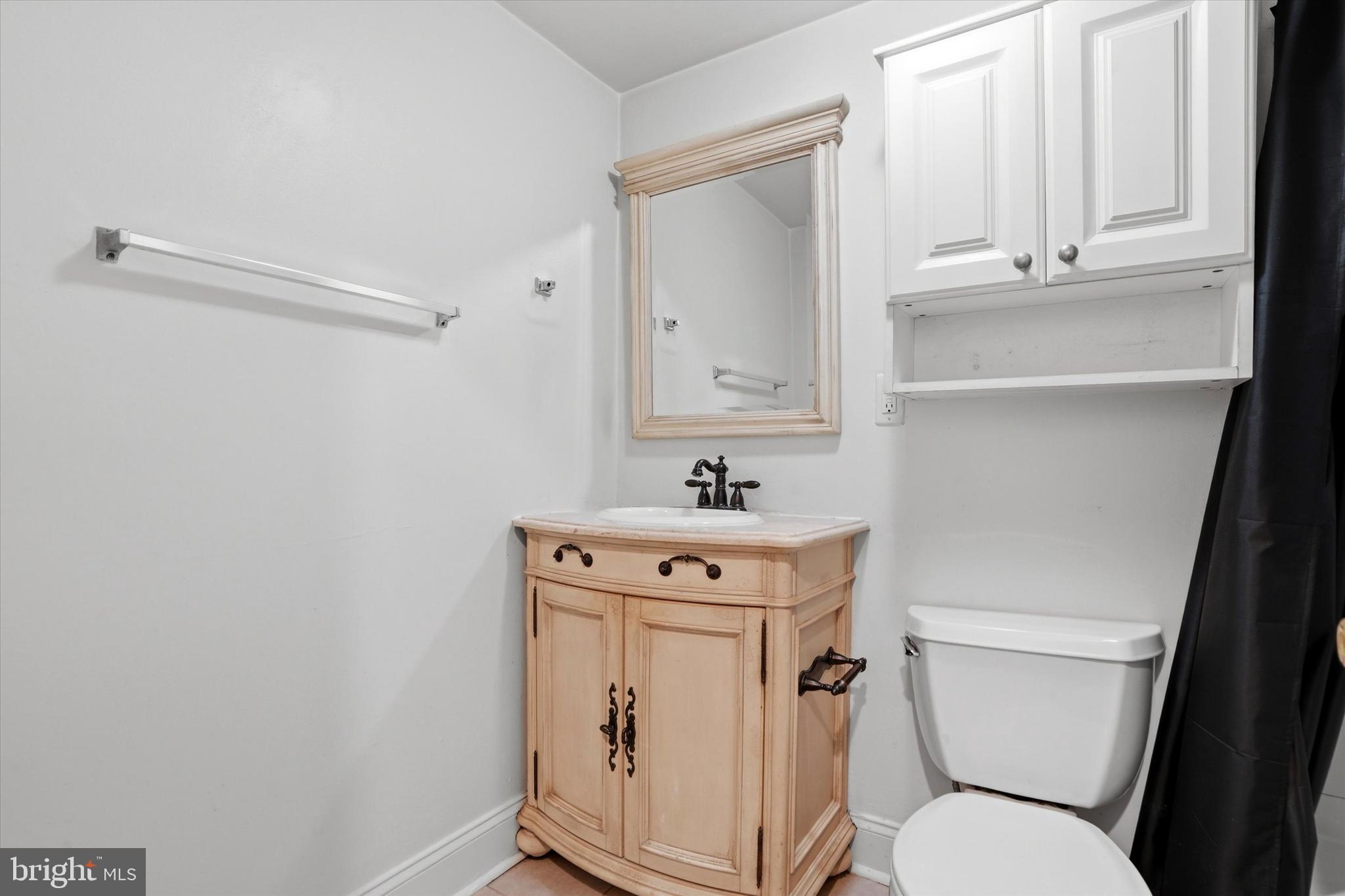 207 Walnut Hill Road, Unit B1 West Chester, PA 19382 - Photo 10 of 13 a bathroom with a sink a toilet a mirror and vanity