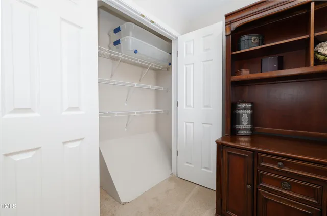 a view of walk in closet with empty racks