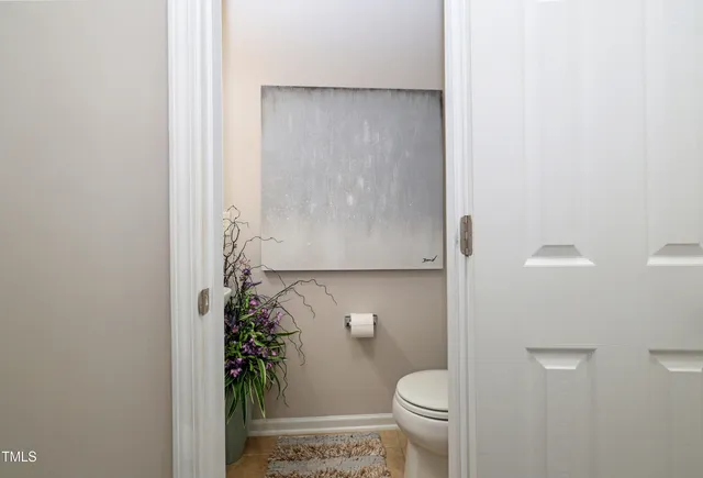 a bathroom with a toilet and a shower curtain