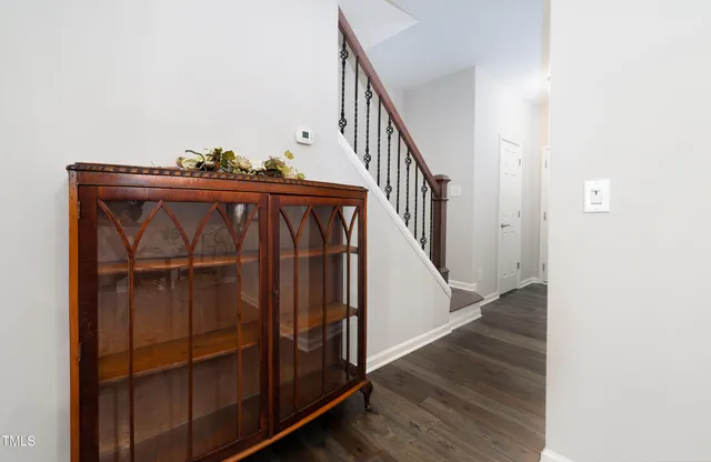 a view of a hallway with wooden floor and staircase