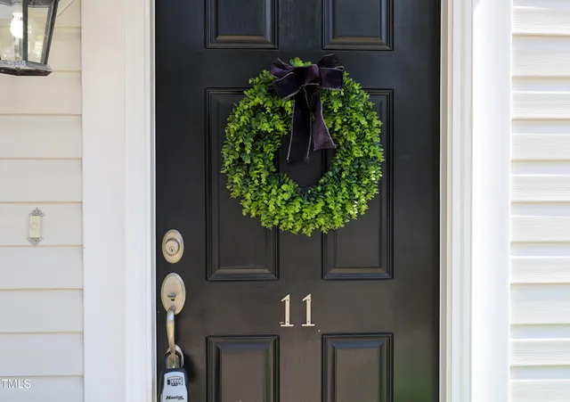 a vase of flowers sitting on a floor in front of a door