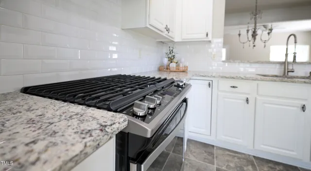 a stove top oven sitting inside of a kitchen